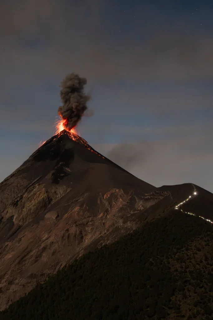 Night view of Fuego volcano eruption with glowing lava in Guatemala
